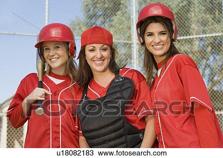 Stock Image - Young female softball players, portrait. Fotosearch