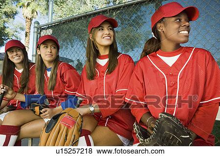 Young female softball players sitting on bench View Large Photo Image Stock Photo - Young female softball players sitting on bench. Fotosearch