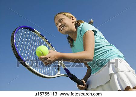 Young girl on tennis court Preparing to Serve, low angle view, close up View Large Photo Image Stock Image - Young girl on tennis court Preparing to Serve, low angle view, close up. Fotosearch