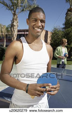 Young man playing ping pong View Large Photo Image Stock Photo - Young man playing ping pong. Fotosearch