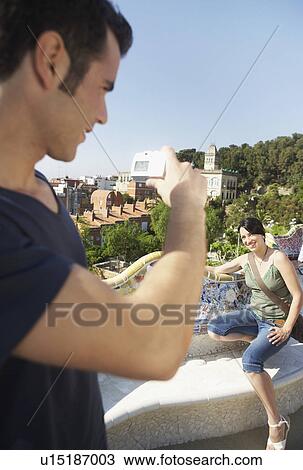 Young man taking photo of woman View Large Photo Image Stock Image - Young man taking photo of woman. Fotosearch