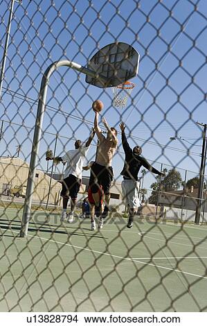 Young men playing basketball View Large Photo Image Picture - Young men playing basketball. Fotosearch