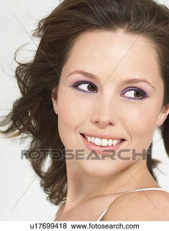 Stock Photo - Young Smiling Woman with wind-swept hair, close up. Fotosearch