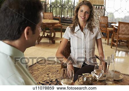 Young woman and man sitting in restaurant. View Large Photo Image Stock Photo - Young woman and man sitting in restaurant.. Fotosearch