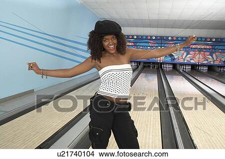 Young woman at bowling alley celebrating, portrait View Large Photo Image Picture - Young woman at bowling alley celebrating, portrait. Fotosearch