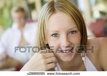 Stock Photography - Young woman on lying on deckchair, portrait, close up. Fotosearch