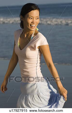 Stock Photography - Young woman smiling on beach. Fotosearch