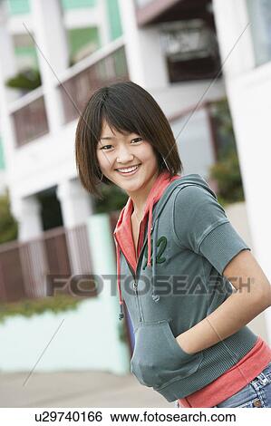 Stock Photograph - Young woman smiling on street. Fotosearch