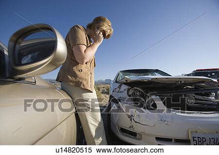 Young woman using mobile phone by car wreckage View Large Photo Image Stock Photography - Young woman using mobile phone by car wreckage. Fotosearch