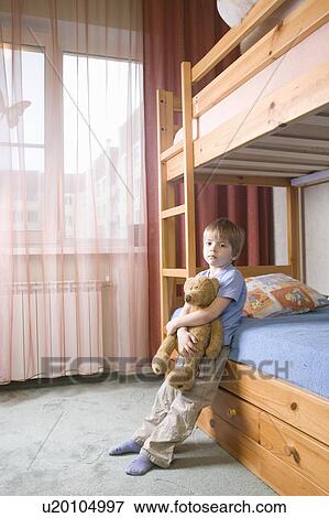 5 year old boy leans on bunk bed holding teddybear View Large Photo Image Stock Photo - 5 year old boy leans on bunk bed holding teddybear. Fotosearch