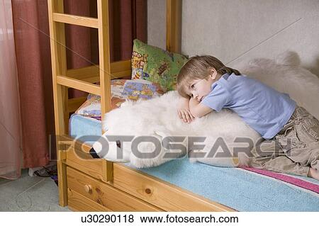 5 year old boy lies on bunk bed with polar bear soft toy View Large Photo Image Stock Photo - 5 year old boy lies on bunk bed with polar bear soft toy. Fotosearch