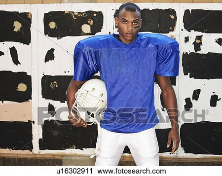 American football player holding helmet, portrait View Large Photo Image Stock Image - American football player holding helmet, portrait. Fotosearch