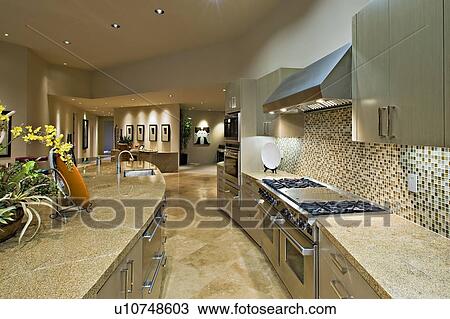 Stock Image - Architecturally designed kitchen and living area. Fotosearch