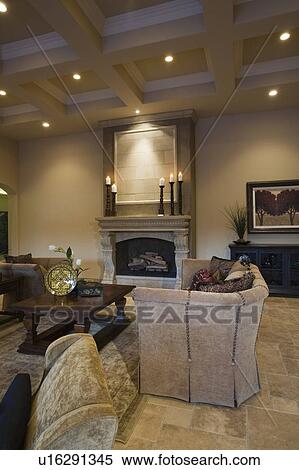 Stock Photography - Armchair in living room with spotlighted ceiling. Fotosearch