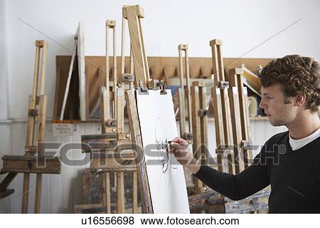 Artist drawing charcoal portrait in studio, side view View Large Photo Image Stock Photo - Artist drawing charcoal portrait in studio, side view. Fotosearch