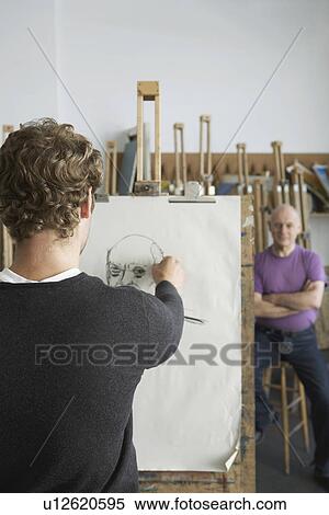 Artist drawing charcoal portrait of model in studio, back view View Large Photo Image Stock Photography - Artist drawing charcoal portrait of model in studio, back view. Fotosearch