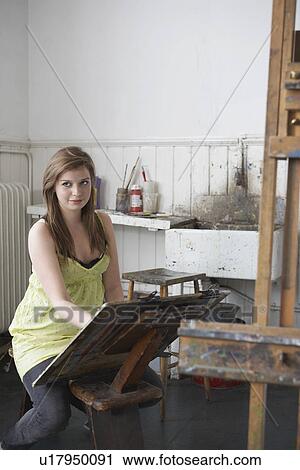 Stock Image - Artist drawing in studio. Fotosearch
