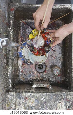 Artist rinsing palette at sink in studio, view from above, close-up of hands View Large Photo Image Stock Image - Artist rinsing palette at sink in studio, view from above, close-up of hands. Fotosearch