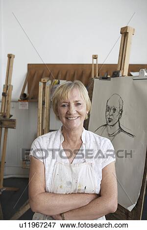 Artist standing by artwork in studio, portrait View Large Photo Image Stock Photo - Artist standing by artwork in studio, portrait. Fotosearch