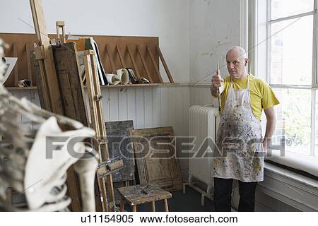 Stock Photography - Artist studying skeleton in studio. Fotosearch