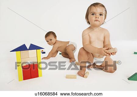 Picture - Baby Boy and Girl Playing With Building Blocks. Fotosearch