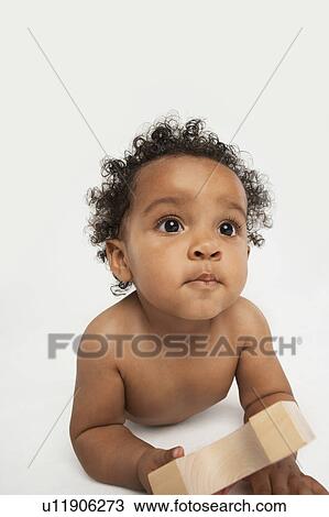 Stock Image - Baby Holding a Building Block. Fotosearch