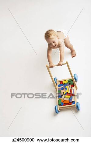 Baby Pushing Cart of Blocks View Large Photo Image Stock Image - Baby Pushing Cart of Blocks. Fotosearch