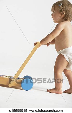 Stock Photography - Baby Pushing Cart of Blocks. Fotosearch