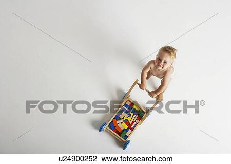 Baby Pushing Toy Cart View Large Photo Image Stock Image - Baby Pushing Toy Cart. Fotosearch