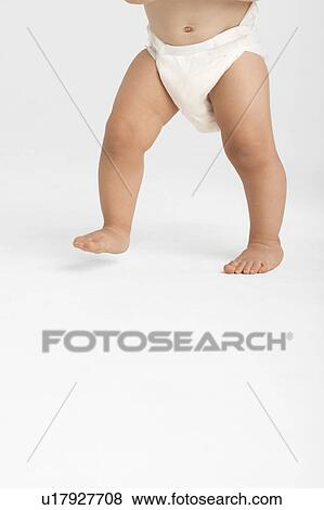 Baby walking, low section View Large Photo Image Stock Photo - Baby walking, low section. Fotosearch