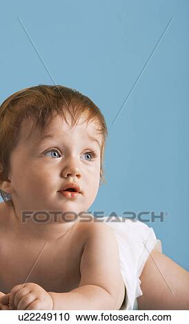 Stock Image - Baby wearing nappy lying on tummy. Fotosearch