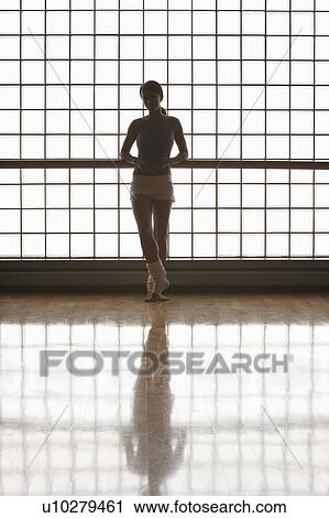 Stock Image - Ballerina in stood by window. Fotosearch