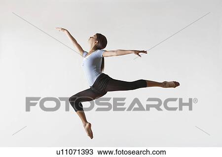 Stock Image - Ballerina Leaping in Mid-air. Fotosearch