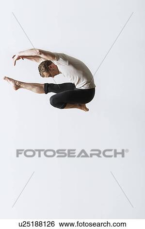 Ballet dancer leaping in mid-air View Large Photo Image Stock Photograph - Ballet dancer leaping in mid-air. Fotosearch