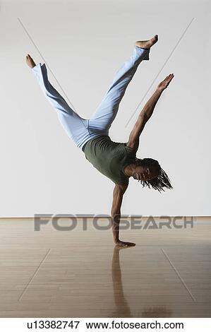 Stock Photo - Ballet Dancer on one hand. Fotosearch