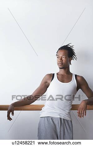 Stock Image - Ballet Dancer relaxing at bar. Fotosearch