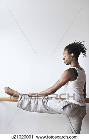 Ballet Dancer stretching at bar View Large Photo Image Stock Image - Ballet Dancer stretching at bar. Fotosearch