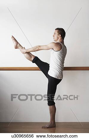 Ballet Dancer Stretching at bar View Large Photo Image Stock Photograph - Ballet Dancer Stretching at bar. Fotosearch
