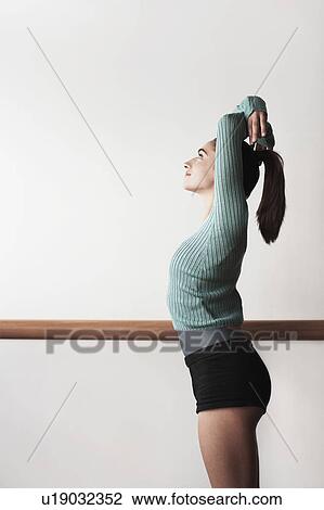 Ballet Dancer with arms overhead at bar View Large Photo Image Stock Image - Ballet Dancer with arms overhead at bar. Fotosearch