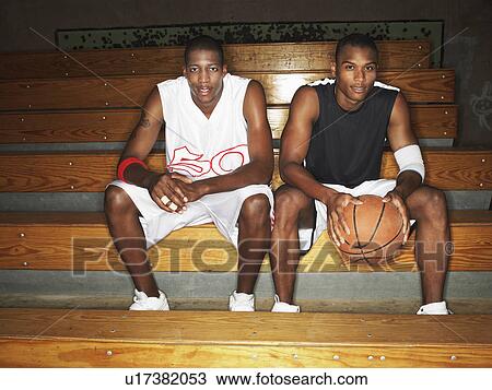Basketball ball players sitting on bench, portrait View Large Photo Image Stock Image - Basketball ball players sitting on bench, portrait. Fotosearch