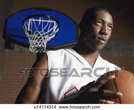 Basketball player holding ball, portrait View Large Photo Image Picture - Basketball player holding ball, portrait. Fotosearch