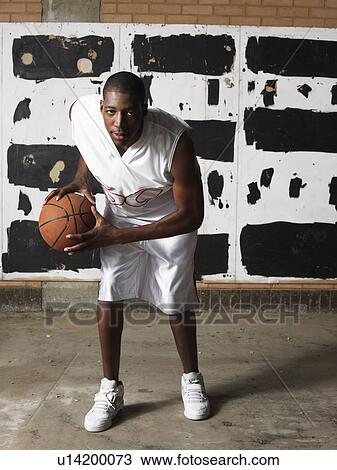Basketball player holding ball, portrait View Large Photo Image Stock Image - Basketball player holding ball, portrait. Fotosearch