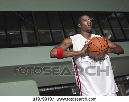 Basketball player preparing to pass ball, portrait View Large Photo Image Stock Photo - Basketball player preparing to pass ball, portrait. Fotosearch