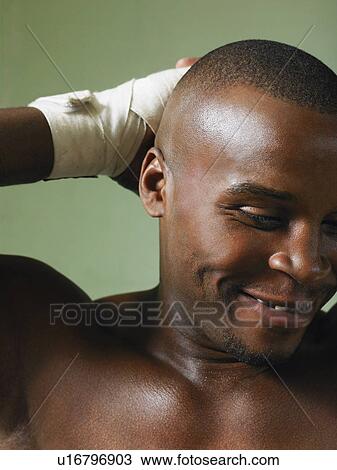 Stock Image - Boxer with hand on head, close-up. Fotosearch