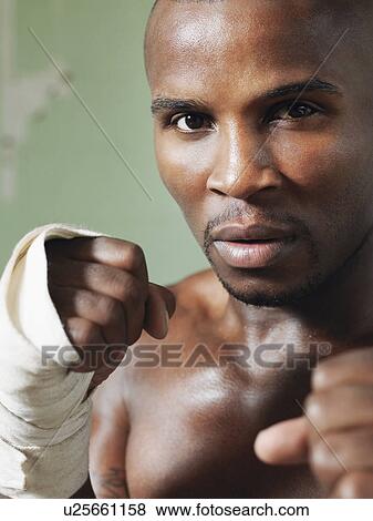 Boxer with raised fists, close-up View Large Photo Image Stock Photo - Boxer with raised fists, close-up. Fotosearch
