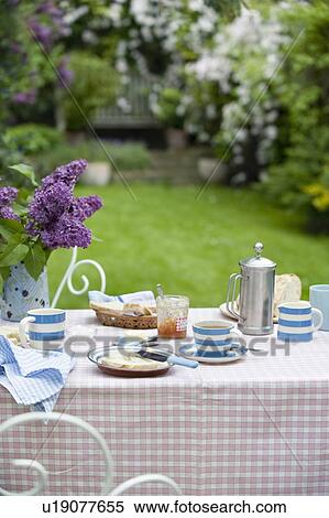 Stock Photography - Breakfast table in back garden. Fotosearch