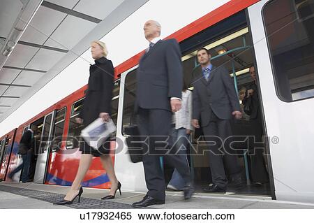 Stock Photography - Business Commuters Getting off a Train, motion blur, low angle view. Fotosearch