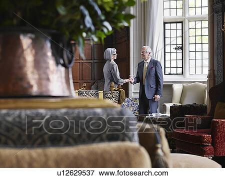 Stock Photo - Business man and woman shaking hands, selective focus. Fotosearch