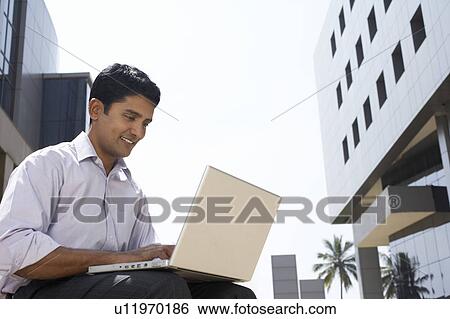 Business man carrying hard hat on city rooftop View Large Photo Image Stock Photograph - Business man carrying hard hat on city rooftop. Fotosearch