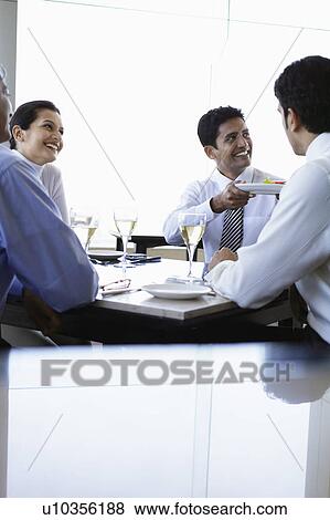 Business man holding meal during business meeting View Large Photo Image Stock Photo - Business man holding meal during business meeting. Fotosearch